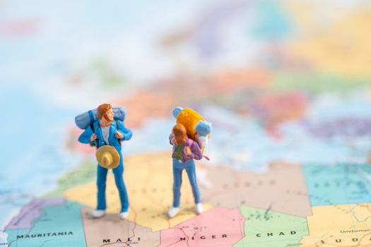 Bangkok, Thailand, July 30, 2021 Miniature people, Two backpacker enjoy to discovery journey travel at amazing on world map.