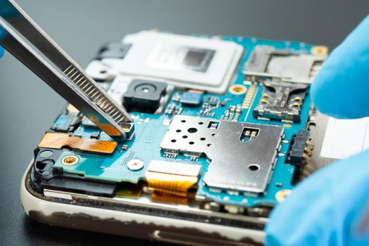 technician repairing inside of hard disk by soldering iron. Integrated Circuit. the concept of data, hardware, technician and technology.