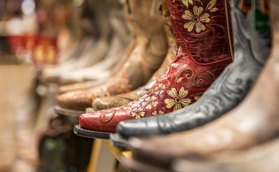 Close-up of new cowboy boots on shelf in a store