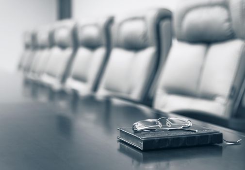 Closeup of on table in empty corporate conference room before business meeting in office