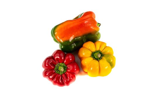 tris peppers of yellow and red color on a white background