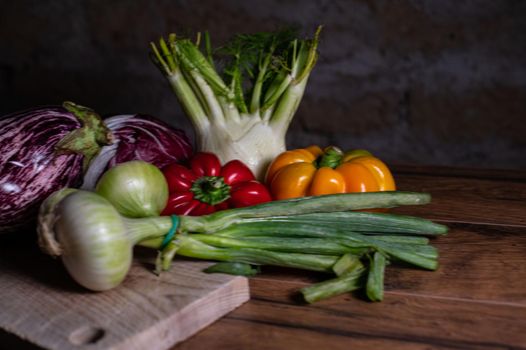 composition of vegetables with cutting board on wooden surface