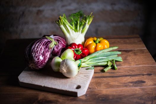 composition of vegetables with cutting board on wooden surface