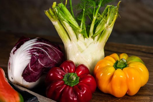 composition of vegetables with cutting board on wooden surface