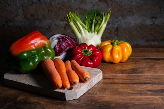 composition of vegetables with cutting board on wooden surface