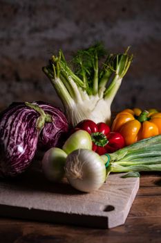composition of vegetables with cutting board on wooden surface