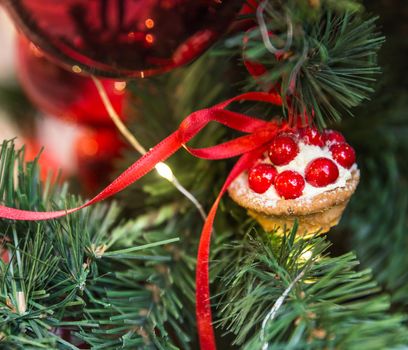 Christmas tree decoration with cupcake dessert and ribbon