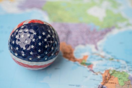 Bangkok, Thailand, May 1, 2021 USA America map at golf ball with flag on world globe map.