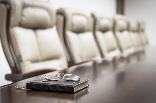 Closeup of on table in empty corporate conference room before business meeting in office