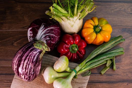 composition of vegetables with cutting board on wooden surface