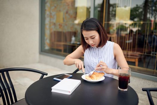 Young woman sitting at a table a cup of coffee breakfast morning