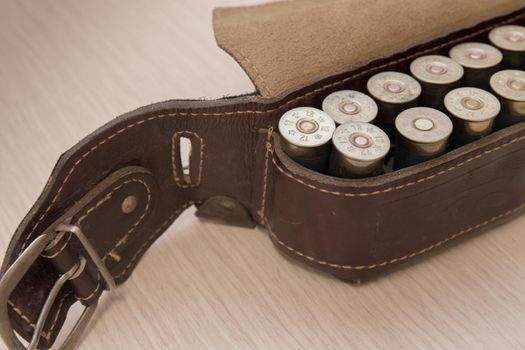 An old cartridge leather belt with shotgun shells