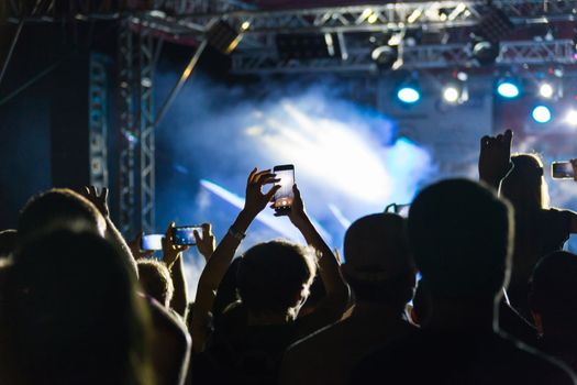 silhouettes of crowd at concert on music festival