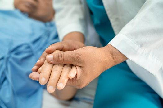 Doctor holding touching hands Asian senior or elderly old lady woman patient with love, care, helping, encourage and empathy at nursing hospital ward, healthy strong medical concept