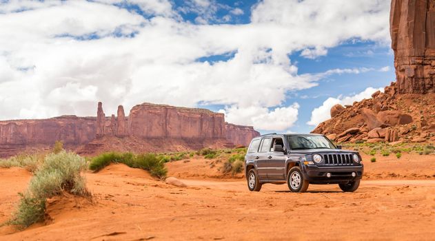 MONUMENT VALLEY, UTAH, USA - MAY 25, 2015 - Offroading through the Monument Valley in a Jeep Patriot. Jeep Patriot is a four-wheel drive off-road and sport utility vehicle (SUV), manufactured by American automaker Chrysler.
