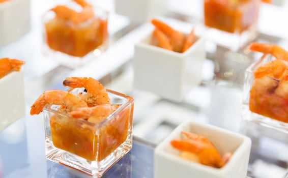 shrimps with sauce served in modern style