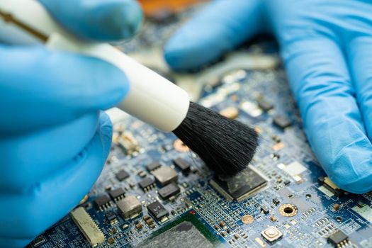 Technician use brush and air blower ball to clean dust in circuit board computer. Repair upgrade and maintenance technology.