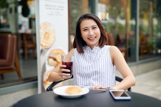 Woman enjoys fresh coffee in the morning at coffee shop 