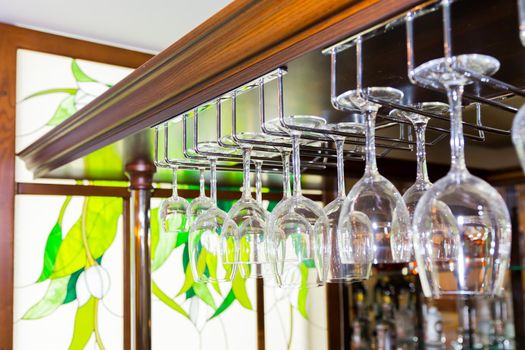 A bunch of glasses hanging upside-down