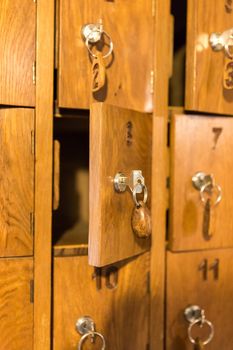 Wooden cells with keys for storing cell phones in Italian restaurant while eating