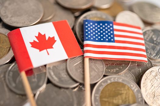 Stack of coins with USA America and Canada flag, finance concept.