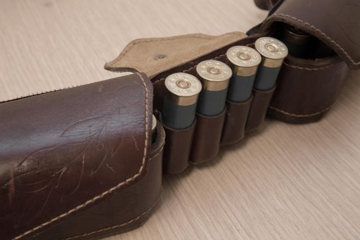 An old cartridge leather belt with shotgun shells