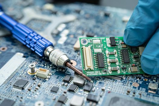 Repairing inside of hard disk by soldering iron. Integrated Circuit. the concept of data, hardware, technician and technology.