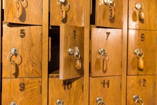 Wooden cells with keys for storing cell phones in Italian restaurant while eating