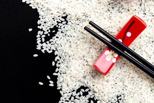Japanese cuisine table setting with rice background and chopsticks