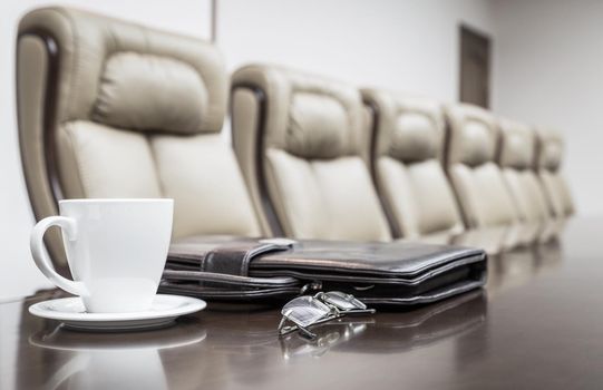Closeup of on table in empty corporate conference room before business meeting in office