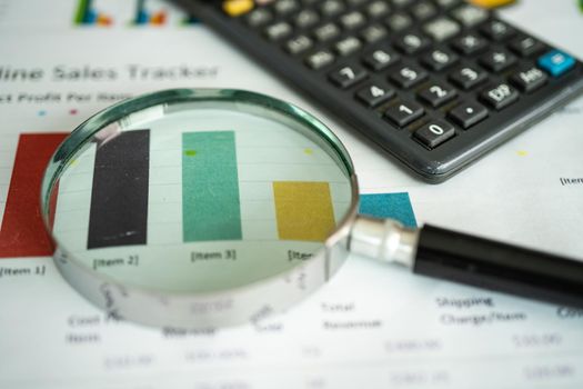 Magnifying glass on charts graphs paper. Financial development, Banking Account, Statistics, Investment Analytic research data economy, Stock exchange trading, Business office company meeting concept.