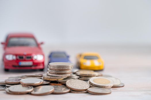 Car on coins background; Car loan, Finance, saving money, insurance and leasing time concepts.