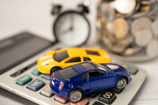 Car and alarm clock on coins, Car loan, Finance, saving money, insurance and leasing time concepts.