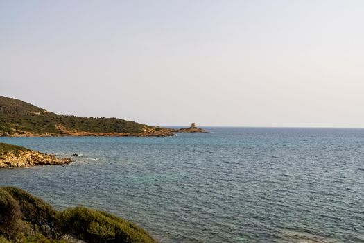 Beautiful view of the southern Sardinian sea. Note the historic Saracen tower on the rock formations.