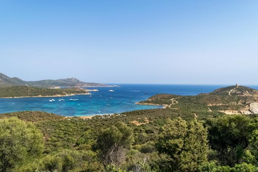 Beautiful view of the southern Sardinian sea. Note the historic Saracen tower on the rock formations.