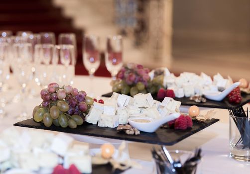 Buffet table with brie cheese and grapes