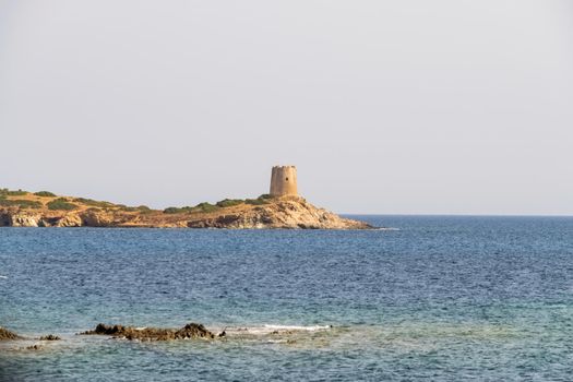 Beautiful view of the southern Sardinian sea. Note the historic Saracen tower on the rock formations.