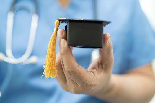 Asian doctor study learn with graduation gap hat in hospital ward : clever bright genius education medicine concept.