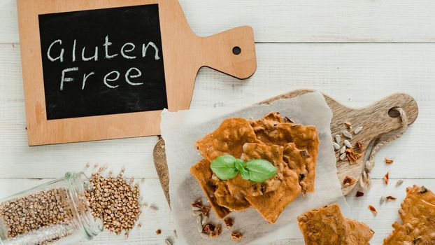 Gluten-freen crispbreads made of buskwheat flour. Green buckwheat flour smoked paprika sunflower seeds ingredients homemade baked crisp bread. Idea recipe snacks gluten free concept. Top view flat lay