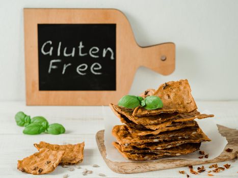 Gluten-freen crispbreads made from buskwheat flour. Green buckwheat flour, smoked paprika, sunflower seeds is ingredients for this homemade baked crisp bread. Idea recipe snacks, gluten-free concept