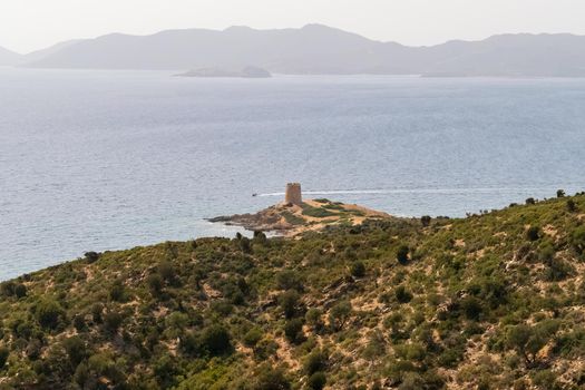 Beautiful view of the southern Sardinian sea. Note the historic Saracen tower on the rock formations.