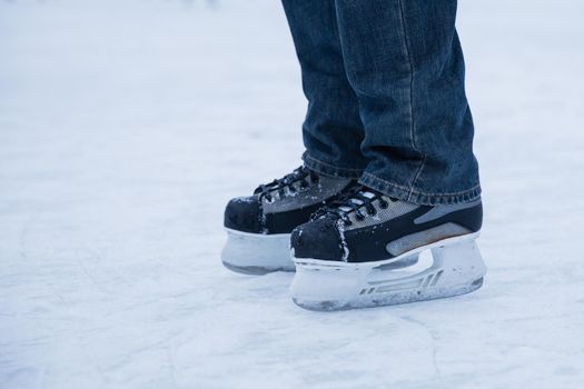man wearing hockey skaters on ice rink