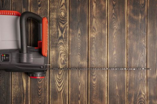 Electric chain saw on wood on a wooden background. Top view. High quality photo