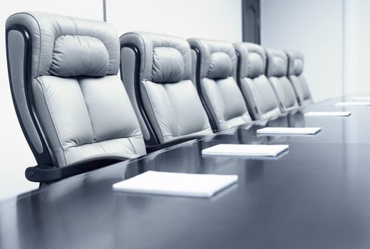 Closeup of on table in empty corporate conference room before business meeting in office