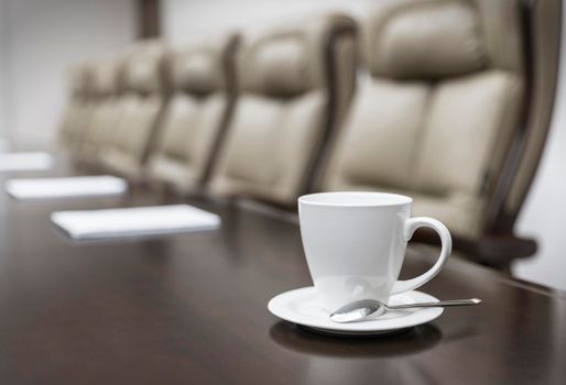 Closeup of on table in empty corporate conference room before business meeting in office