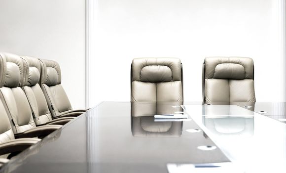conference room with wooden table and beige leather armchairs