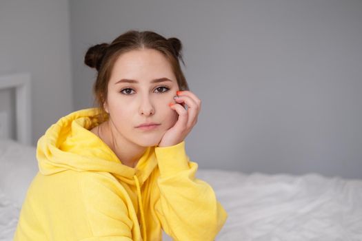 charming sweet young woman in yellow hoodie.