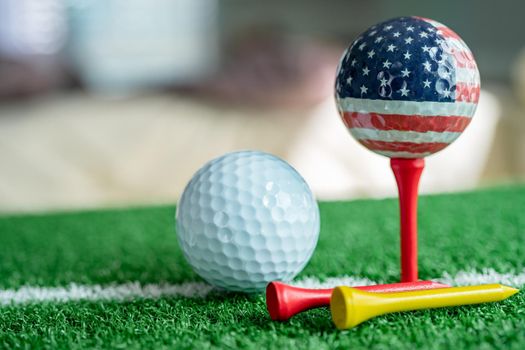 Golf globe world ball with USA flag on green lawn or field, most popular sport in the world.