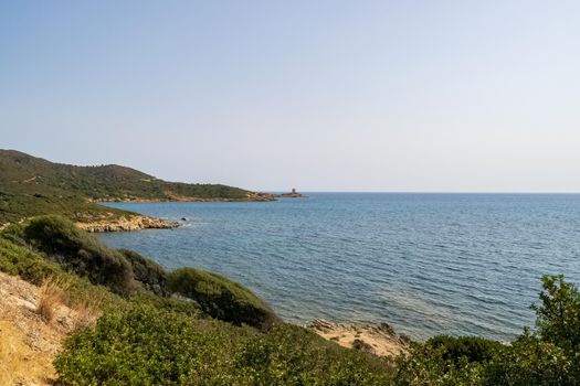 Beautiful view of the southern Sardinian sea. Note the historic Saracen tower on the rock formations.