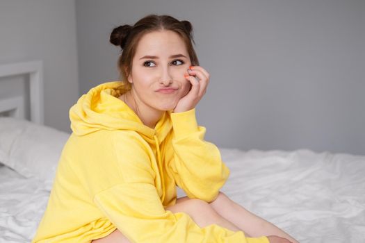 charming sweet young woman in yellow hoodie.